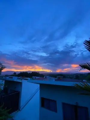a sunset from the balcony of a building at Amá in Puerto Limón