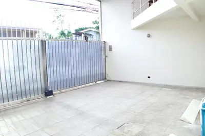 an empty room with a fence and a tile floor at Amá in Puerto Limón