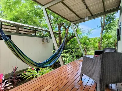 a porch with a hammock on a deck at Casa Abierta Playa Juquillal 2 habitaciones in Santa Cruz