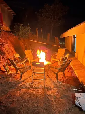 a fire pit with chairs and a table with a fire at Skyline Great View in Naranjo
