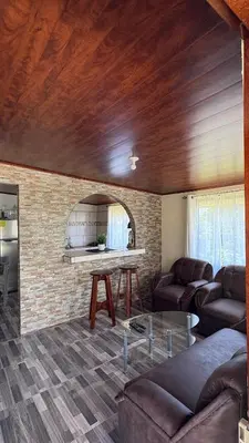 a living room with a couch and a table at Skyline Great View in Naranjo