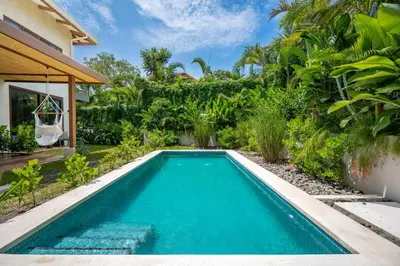a swimming pool in the backyard of a villa at Casa Cheetah Gated Luxury Villa with Guest House in Tamarindo