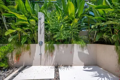 a fountain in a garden with trees and plants at Casa Cheetah Gated Luxury Villa with Guest House in Tamarindo