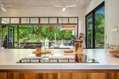 a kitchen with a counter top and a large window at Casa Cheetah Gated Luxury Villa with Guest House in Tamarindo