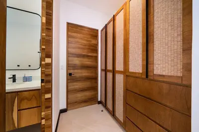 a walk in closet with wooden doors and a sink at Casa Cheetah Gated Luxury Villa with Guest House in Tamarindo