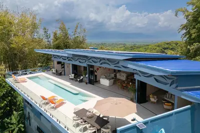 an aerial view of a house with a swimming pool at Villa Buddha Belly OceanMountain top views in Quepos