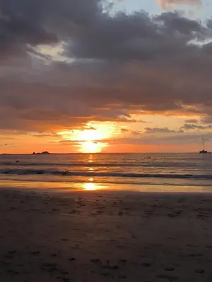 a sunset on a beach with the ocean at Casa Abierta Playa Juquillal 1 habitacion in Santa Cruz