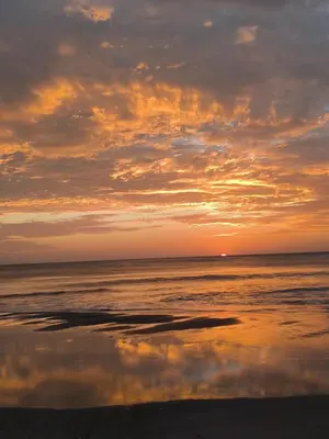 a sunset on a beach with the ocean at Casa Abierta Playa Juquillal 1 habitacion in Santa Cruz