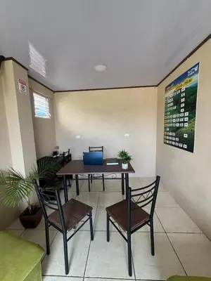 an empty waiting room with a table and chairs at Hotel Nativo Arenal in Fortuna