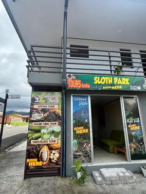 a store front of a sloth park with signs at Hotel Nativo Arenal in Fortuna