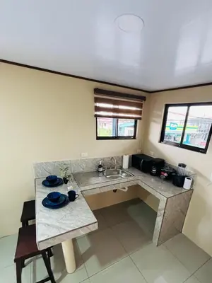a kitchen with a sink and a counter top at Hotel Nativo Arenal in Fortuna