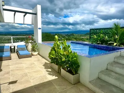 a patio with a swimming pool on a house at Luxury New apartment! Infinity Pool! Adults only in Tapantí