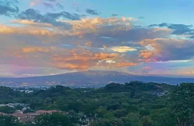 a cloudy sky above a city with trees at Luxury New apartment! Infinity Pool! Adults only in Tapantí