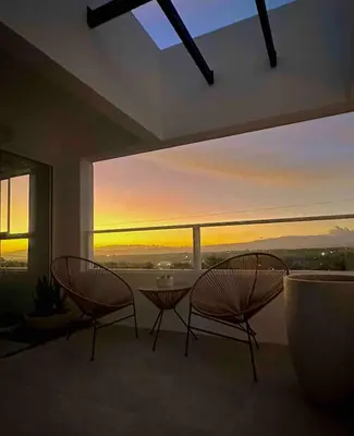 two chairs and a table in a room with a view at Luxury New apartment! Infinity Pool! Adults only in Tapantí