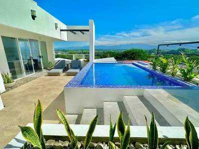 a villa with a swimming pool in a yard at Luxury New apartment! Infinity Pool! Adults only in Tapantí