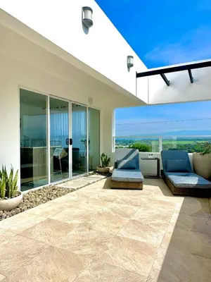a living room with two chairs and a patio at Luxury New apartment! Infinity Pool! Adults only in Tapantí