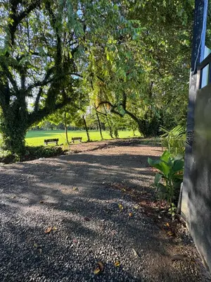a park with two benches on a gravel road at Pelíkano Uvita in Uvita