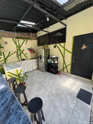 a patio with two chairs and a refrigerator in a building at Pelíkano Uvita in Uvita