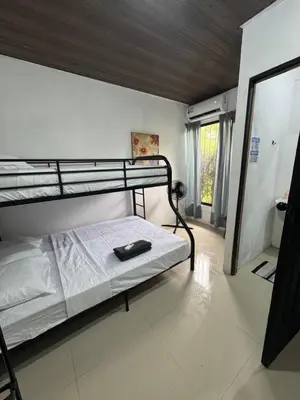 a bedroom with a bunk bed and a mirror at Pelíkano Uvita in Uvita