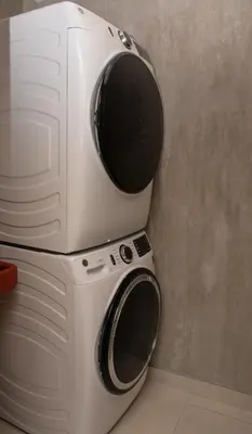 a washer and dryer stacked on top of each other at Bird & Surf 2BD Retreat Jungle Views Pool Gym in Jacó