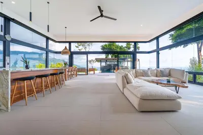 a living room with a couch and a bar at NEW Luxury! Panoramic views-Pool-Private-Gated in Portalón