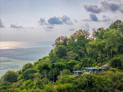 a house on top of a hill with trees at NEW Luxury! Panoramic views-Pool-Private-Gated in Portalón
