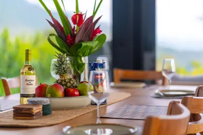 a table with a bottle of wine and a bowl of fruit at NEW Luxury! Panoramic views-Pool-Private-Gated in Portalón