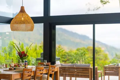 a dining room with a table and chairs and windows at NEW Luxury! Panoramic views-Pool-Private-Gated in Portalón