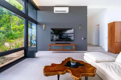 a living room with a couch and a table at NEW Luxury! Panoramic views-Pool-Private-Gated in Portalón