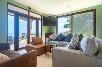 a living room with two couches and a tv at 1hr SJO Airport-Ocean views-Gated Beachclub-Pool in Tarcoles