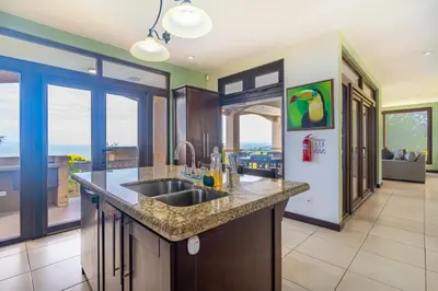 a kitchen with a sink and a counter at 1hr SJO Airport-Ocean views-Gated Beachclub-Pool in Tarcoles