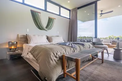 a bedroom with a large bed and a large window at NEW! Modern-Luxury-3 suites-pool-Ojochal-100MBPS in Ojochal