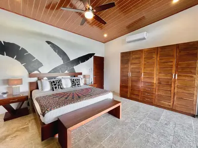 a bedroom with a bed and a ceiling fan at 3 Suites-Views-Great pool-Near Dominical-Luxury in Laguna