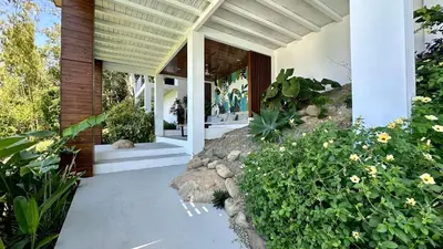 a porch of a house with flowers and plants at 3 Suites-Views-Great pool-Near Dominical-Luxury in Laguna