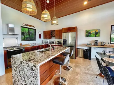 a kitchen with a large island with a counter top at 3 Suites-Views-Great pool-Near Dominical-Luxury in Laguna