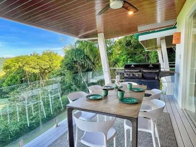 a porch with a table and chairs and a grill at 3 Suites-Views-Great pool-Near Dominical-Luxury in Laguna