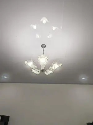 a chandelier hanging from the ceiling in a room at Happy Family in Quepos