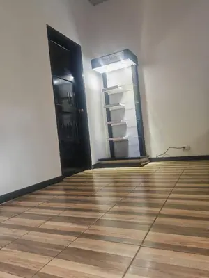 an empty room with an open door and a refrigerator at Happy Family in Quepos