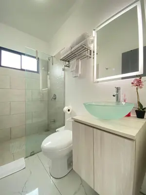 a bathroom with a sink and a toilet and a shower at El Chante cerca de playas, piscinas y vistas a la montaña in Herradura