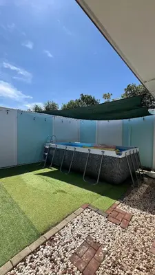 a patio with a table and a swing at Casa Brisa with a private pool in Bejuco in Bejuco