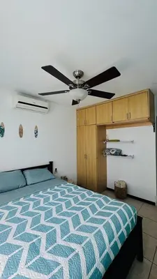 a bedroom with a bed and a ceiling fan at Casa Brisa with a private pool in Bejuco in Bejuco
