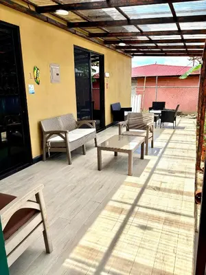a patio with a bunch of benches and tables at En-suite Paraiso #1 in Parrita
