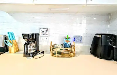 a kitchen counter with a coffeemaker and a coffee maker at Upscale Tropical Retreat - 4BR in Gated Resort in Jacó