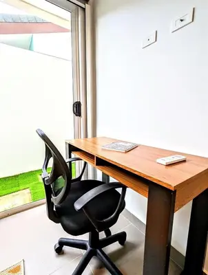 an office with a desk and a chair and a window at Upscale Tropical Retreat - 4BR in Gated Resort in Jacó