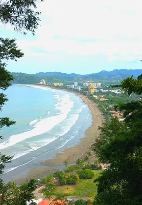 a view of a beach with buildings and the ocean at Upscale Tropical Retreat - 4BR in Gated Resort in Jacó