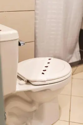 a white toilet with a controller on top of it at Cozy Condo with Panoramic Hillside Views from Rooftop Terrace and Short Walk to Beach in Coco