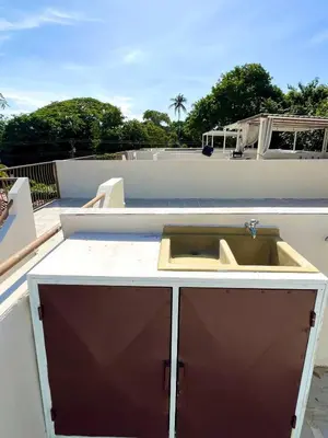 a kitchen sink on top of a roof at Cozy Condo with Panoramic Hillside Views from Rooftop Terrace and Short Walk to Beach in Coco