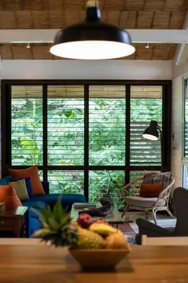 a living room with a table with a bowl of fruit at Art Bungalow Walking distance to the beach in Santa Teresa Beach