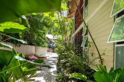 a garden path next to a house with plants at Art Bungalow Walking distance to the beach in Santa Teresa Beach