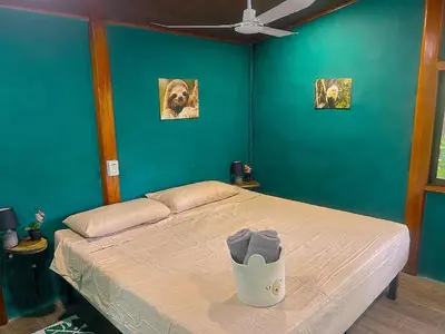 a bedroom with a bed with a blue wall at Java blue banana in Santa Cruz